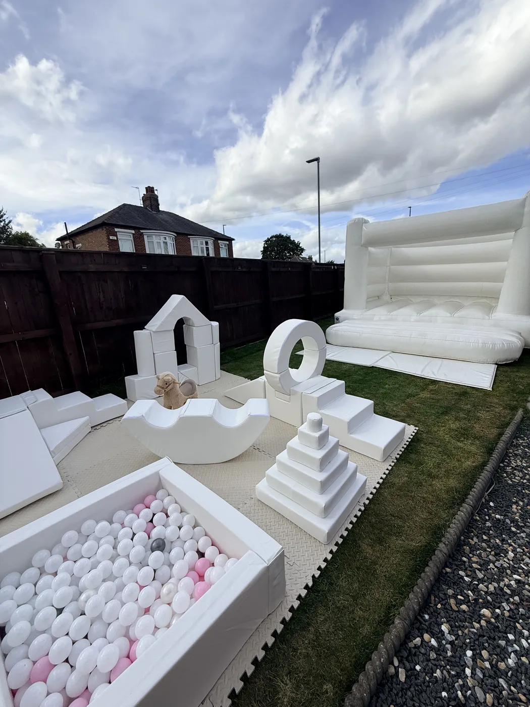 White soft play, ball pool and inflatable set up outdoors